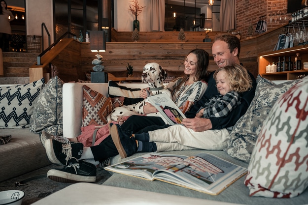 Family with dog reading a book