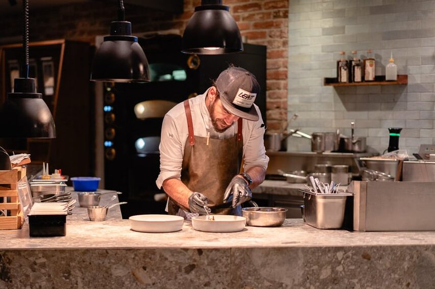 Küchenchef beim Anrichten der Speisen in LUKE'S Wohnzimmer